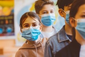 Kids standing in line in masks